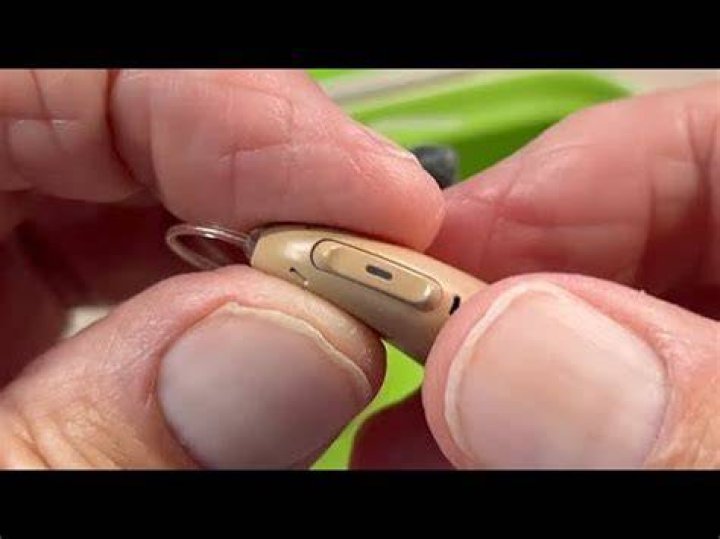 How do I adjust the volume on my Phonak hearing aid?
