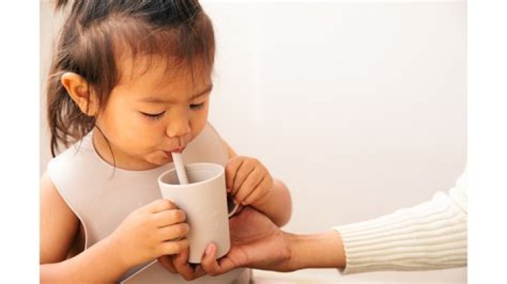 How do you transfer water from one cup to another with a straw?
